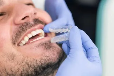 orthodontist placing a patient's Invisalign aligners